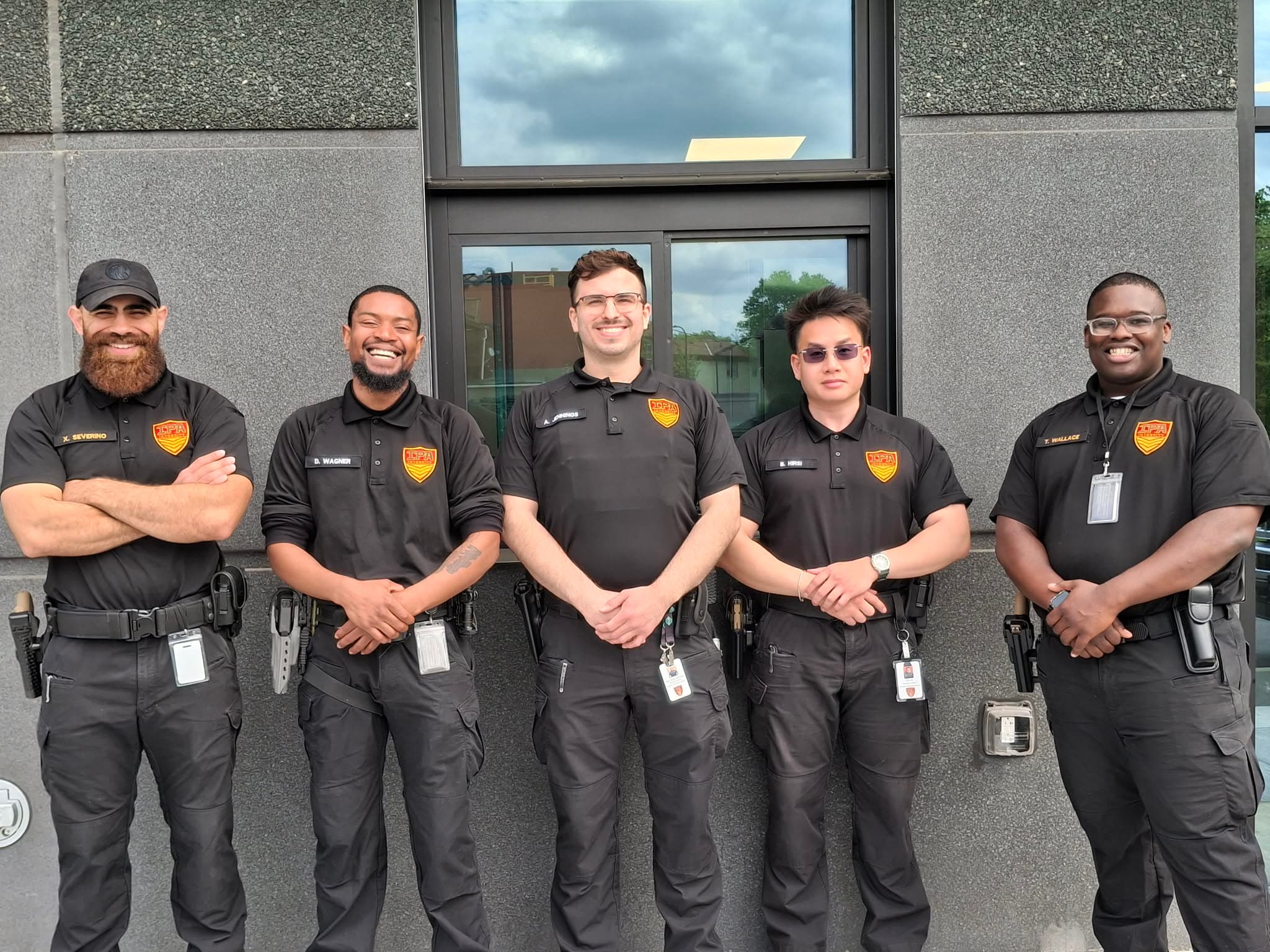 The Integrity Protection Agency officer team standing together in uniform outside a Minnesota building